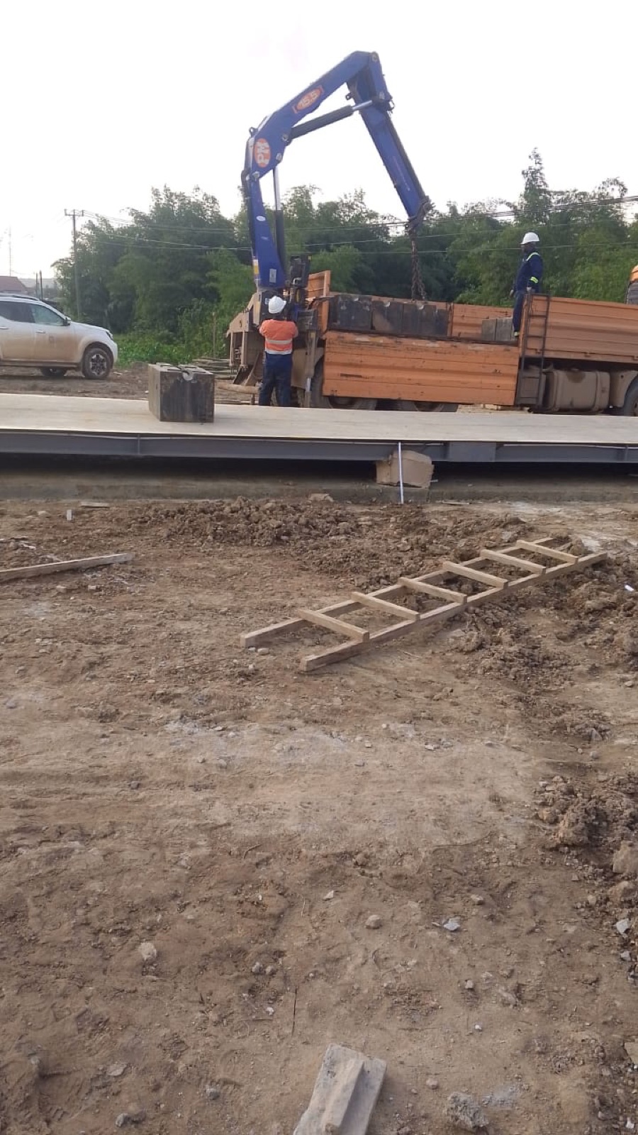 Crane placing a weighbridge platform on site