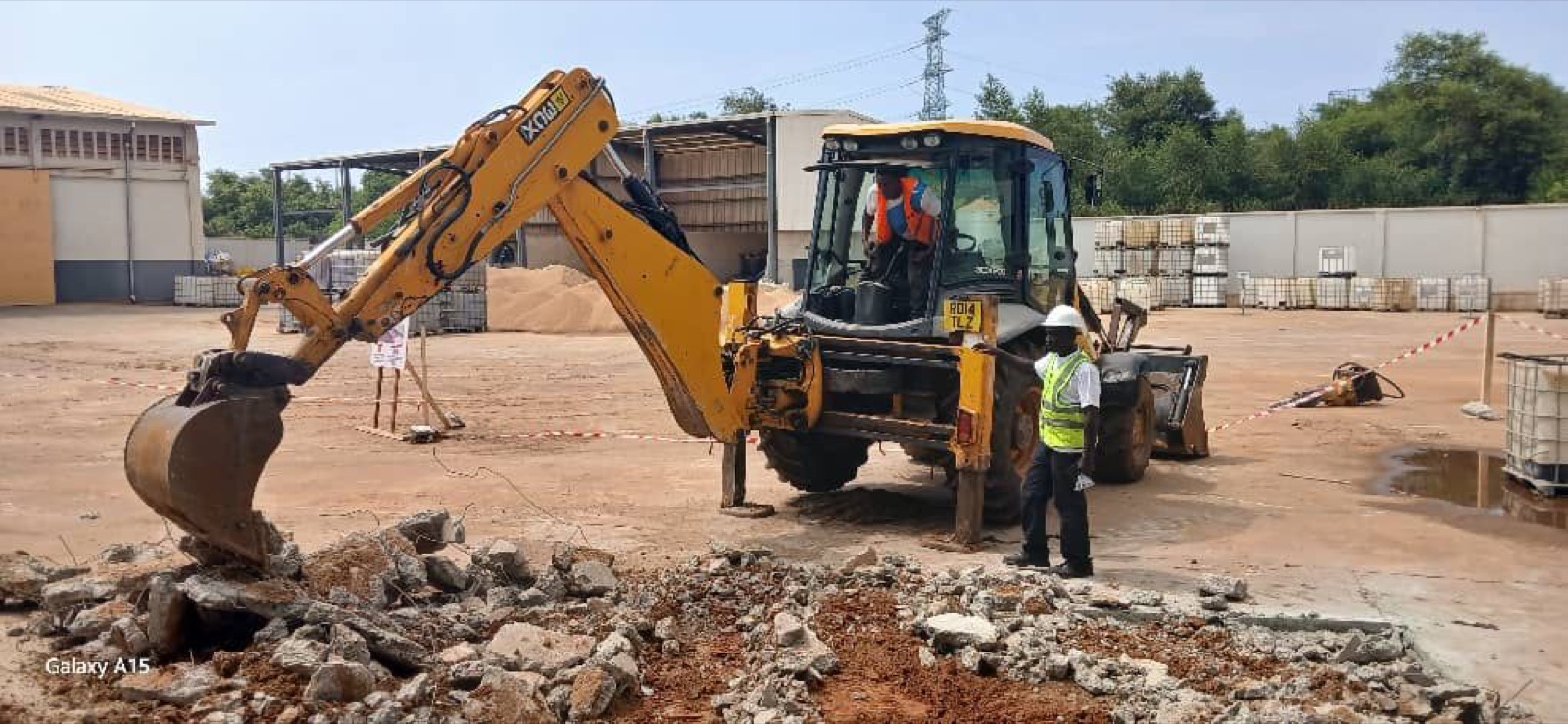 Excavator and worker preparing a weighbridge site