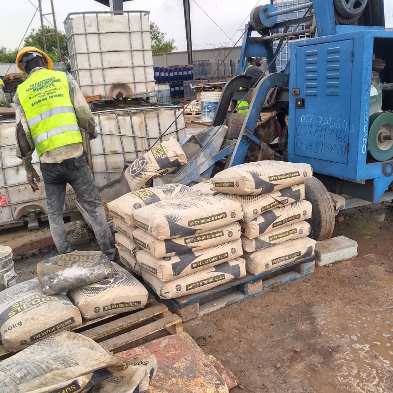 Worker unloading cement bags on site