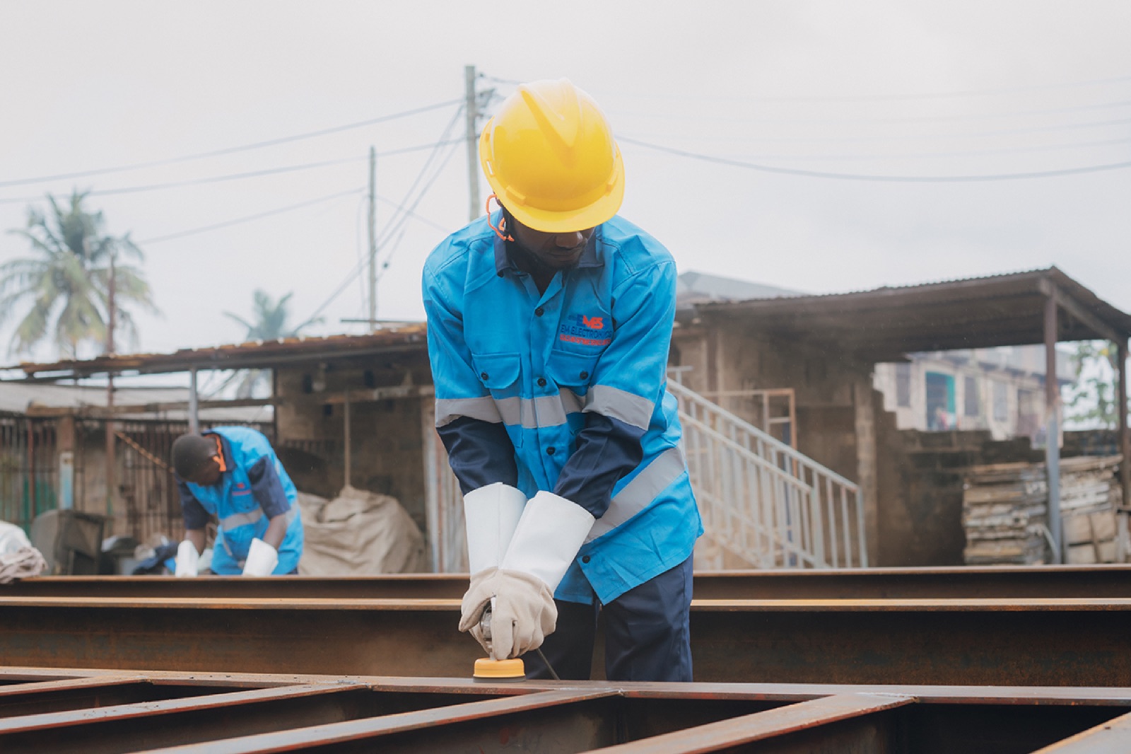 EMESS technician grinding a weighbridge steel beam